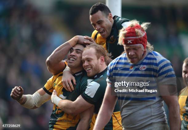 George Pisi of Saints celebrates his third try with team mates Alex Day and Kahn Fotuali'i during the LV= Cup Semi Final match between Northampton...