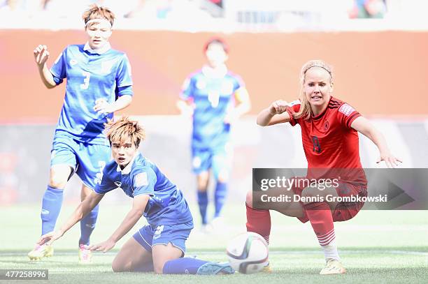 Lena Petermann of Germany passes the ball under the pressure of Natthakarn Chinwong of Thailand during the FIFA Women's World Cup Canada 2015 Group B...