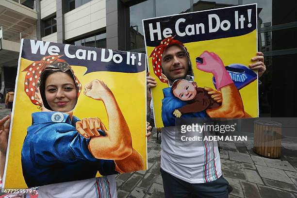 Couple pose for a picture parodying the "We can do it" American propaganda poster during a march in central Ankara as part of the "International...