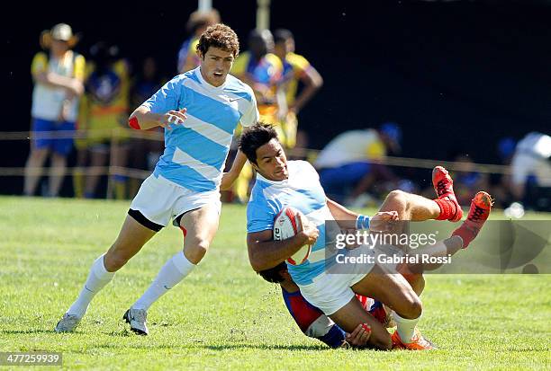 Joaquin Paz is stopped by Paraguayan defense during Men's rugby qualifiers during day two of the X South American Games Santiago 2014 at Centro de...