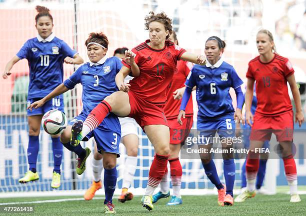 Josephine Henning of Germany is challegend by Natthakarn Chinwong of Thailand during the FIFA Women's World Cup 2015 Group B match between Thailand...