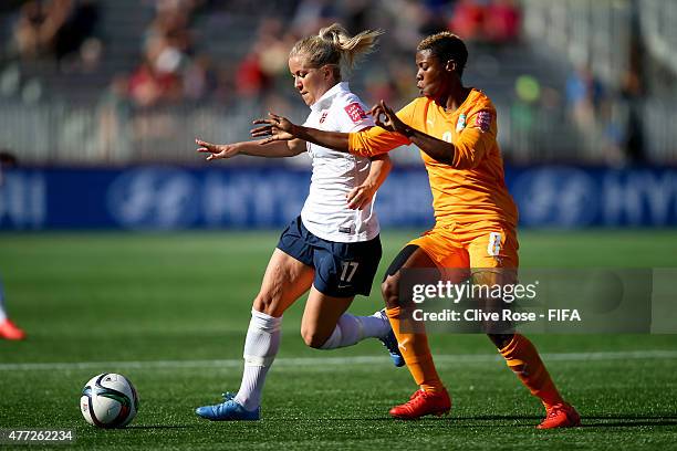 Lene Mykjaland of Norway is challenged by Ines Nrehy of Cote D'Ivoire during the FIFA Women's World Cup 2015 Group B match between Cote D'Ivoire and...