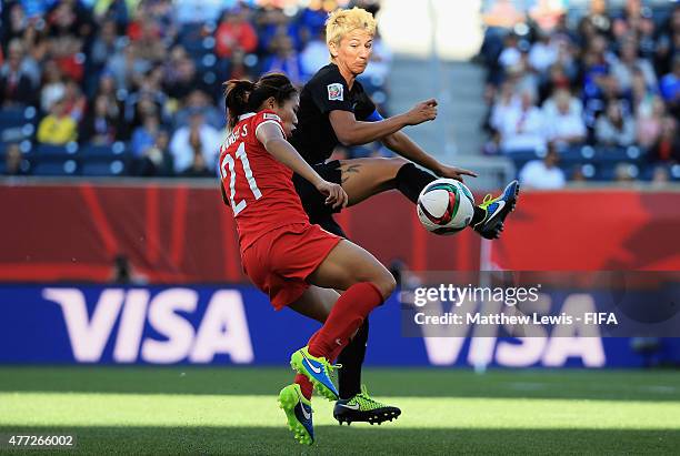 Abby Erceg of New Zealand blocks a shot from Wang Lisi of China during the FIFA Women's World Cup 2015 group A match between China PR and New Zealand...