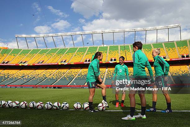 Leena Khamis of Australia, Tameka Butt, Hayley Raso and Ashleigh Sykes talk together before a training session at Commonwealth Stadium on June 15,...