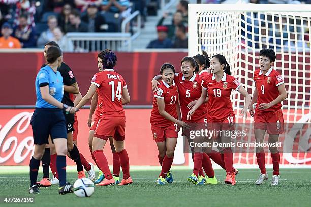 Lisi Wang of China PR celebrates with team mates as she scores their first goal from a penalty during the FIFA Women's World Cup Canada 2015 Group A...