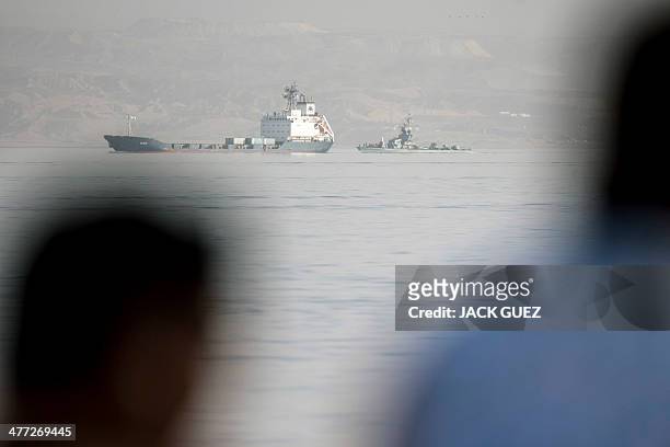 People look at the Panamanian-flagged Klos-C being escorted into the southern Israeli port of Eilat by Israeli warships on March 8, 2014 after it was...