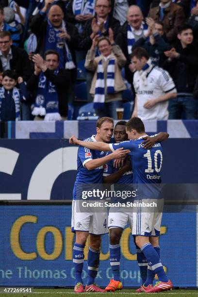 Chinedu Obasi of Schalke celebrates after scoring his team's third goal with team mate Benedikt Hoewedes and Julian Draxler during the Bundesliga...