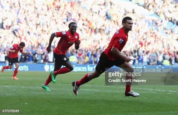 Steven Caulker of Cardiff City celebrates with Kenwyne Jones as he scores their second goal during the Barclays Premier League match between Cardiff...