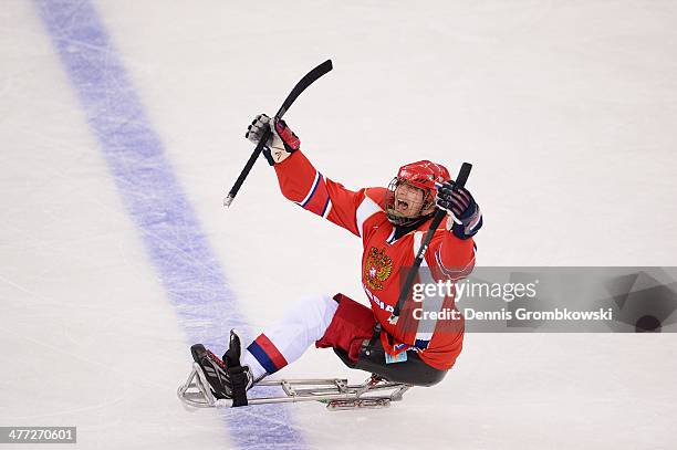 Vasilii Varlakov of Russia celebrates after scoring the first goal during the Ice Sledge Hockey Preliminary Round Group A match between the Russia...