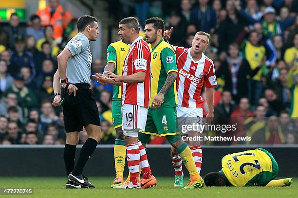 Jonathan Walters of Stoke is shown the red card by referee Andre Marriner following his challenge on Alexander Tettey of Norwich during the Barclays...