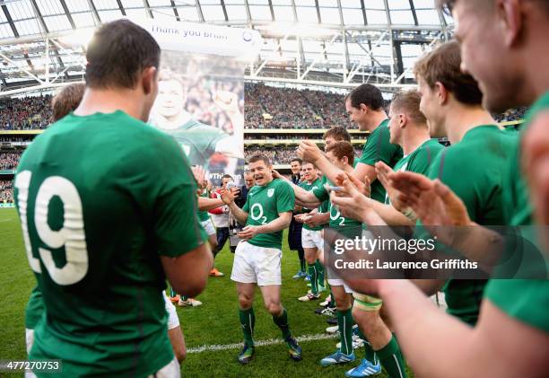 Brian O'Driscoll of Ireland is applauded off the field by his team mates after his last home appearance the RBS Six Nations match between Ireland and...