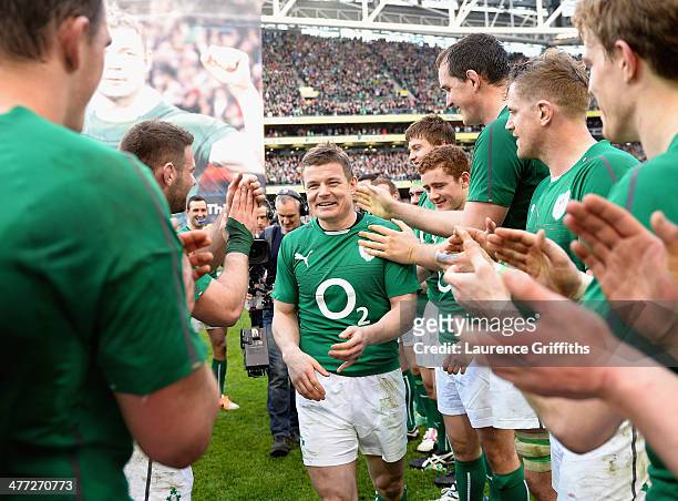 Brian O'Driscoll of Ireland is applauded off the field by his team mates after his last home appearance the RBS Six Nations match between Ireland and...