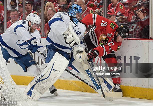 Jonathan Toews of the Chicago Blackhawks works to get the puck against goalie Ben Bishop of the Tampa Bay Lightning as Victor Hedman of the Tampa Bay...