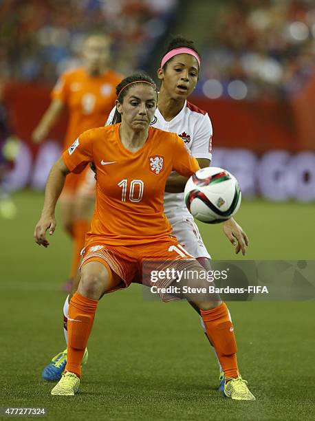 Danielle van de Donk of Netherlands challenges for the ball with Ashley Lawrence of Canada during the FIFA Women's World Cup 2015 group A match...