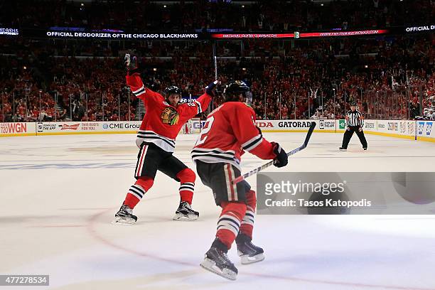 Duncan Keith of the Chicago Blackhawks celebrates with teammate Brandon Saad after scoring a goal in the second period against Ben Bishop of the...