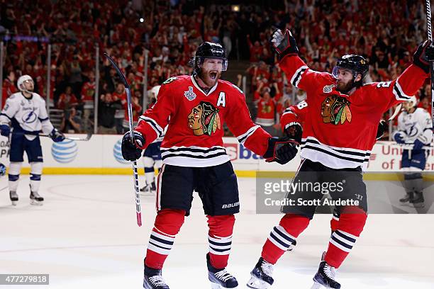 Duncan Keith of the Chicago Blackhawks celebrates his goal with teammate Brandon Saad against the Tampa Bay Lightning in the second period of Game...
