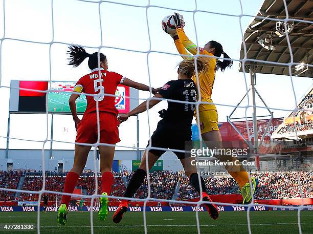 Goalkeeper Wang Fei of China PR saves a shot against Rosie White of New Zealand during the FIFA Women's World Cup Canada 2015 Group A match between...