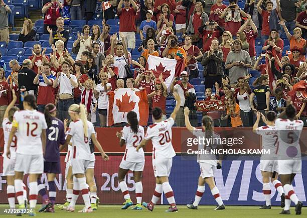 Fans cheer Canada's national team after their 1-1 draw against the Netherlands in a 2015 FIFA Women's World Cup Group A match at the Olympic Stadium...
