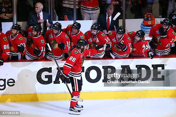 Patrick Kane of the Chicago Blackhawks celebrates with his teammates on the bench after scoring a goal in the third period against the Tampa Bay...