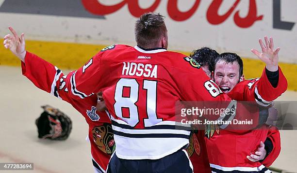 Corey Crawford of the Chicago Blackhawks celebrates with teammates Marian Hossa, Andrew Shaw and Jonathan Toews after defeating the Tampa Bay...