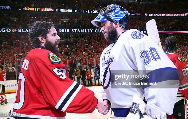 Corey Crawford of the Chicago Blackhawks shakes hands with Ben Bishop of the Tampa Bay Lightning after the Blackhawks won Game Six by a score of 2-0...