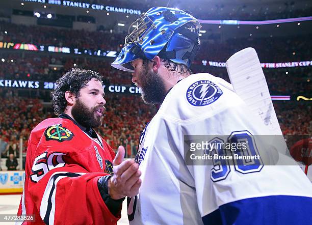 Corey Crawford of the Chicago Blackhawks shakes hands with Ben Bishop of the Tampa Bay Lightning after the Blackhawks won Game Six by a score of 2-0...