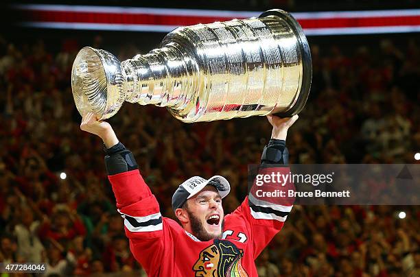 Jonathan Toews of the Chicago Blackhawks celebrates by hoisting the Stanley Cup after defeating the Tampa Bay Lightning by a score of 2-0 in Game Six...