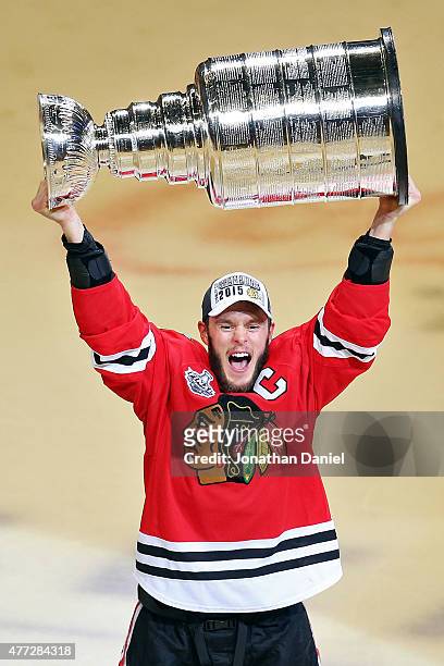 Jonathan Toews of the Chicago Blackhawks celebrates by hoisting the Stanley Cup after defeating the Tampa Bay Lightning by a score of 2-0 in Game Six...