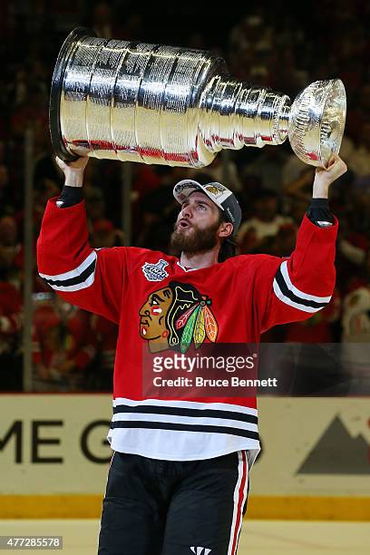 Brandon Saad of the Chicago Blackhawks celebrates by hoisting the Stanley Cup after defeating the Tampa Bay Lightning by a score of 2-0 in Game Six...
