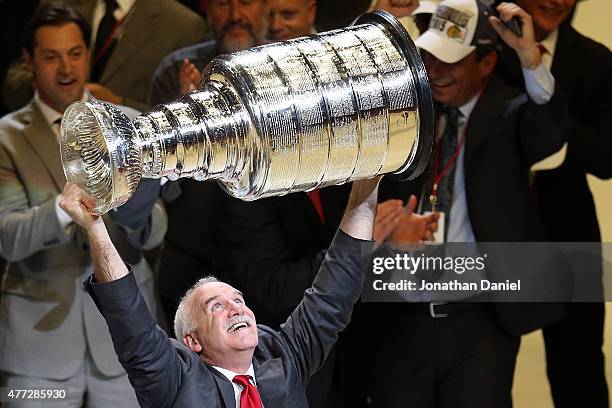 Head coach Joel Quenneville of the Chicago Blackhawks celebrates by hoisting the Stanley Cup after defeating the Tampa Bay Lightning by a score of...