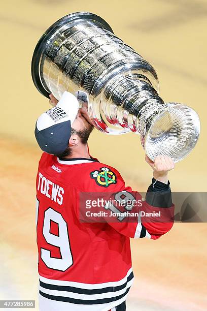 Jonathan Toews of the Chicago Blackhawks celebrates by hoisting the Stanley Cup after defeating the Tampa Bay Lightning by a score of 2-0 in Game Six...