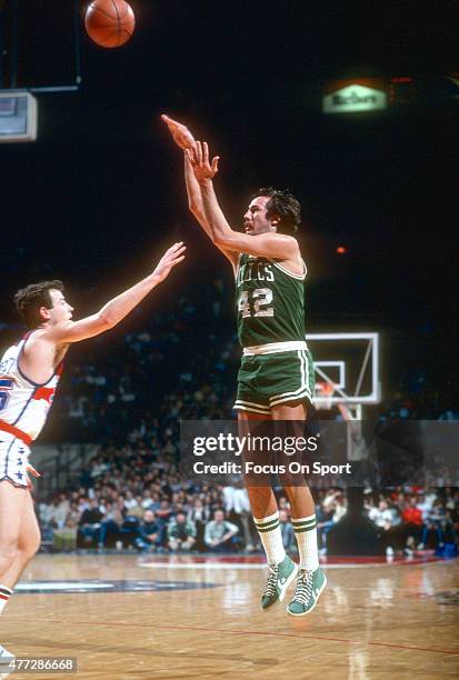 Chris Ford of the Boston Celtics shoots over Kevin Grevey of the Washington Bullets during an NBA basketball game circa 1980 at the Capital Centre in...