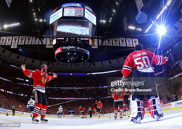 Jonathan Toews and Corey Crawford of the Chicago Blackhawks celebrate after defeating the Tampa Bay Lightning by a score of 2-0 in Game Six to win...