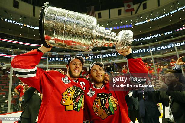 Jonathan Toews and Patrick Kane of the Chicago Blackhawks celebrate by hoisting the Stanley Cup after defeating the Tampa Bay Lightning by a score of...