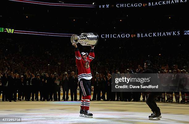 Jonathan Toews of the Chicago Blackhawks hoists the Stanley Cup in celebration of his team's 2-0 victory over the Tampa Bay Lightning in Game Six of...