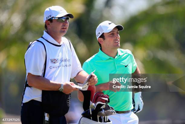 Francesco Molinari of Italy waits with his caddie Jason Hempleman on the first hole during the third round of the World Golf Championships-Cadillac...