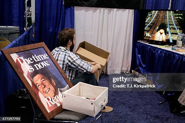 An exhibitor plays a video game in their booth during the 41st annual Conservative Political Action Conference at the Gaylord International Hotel and...