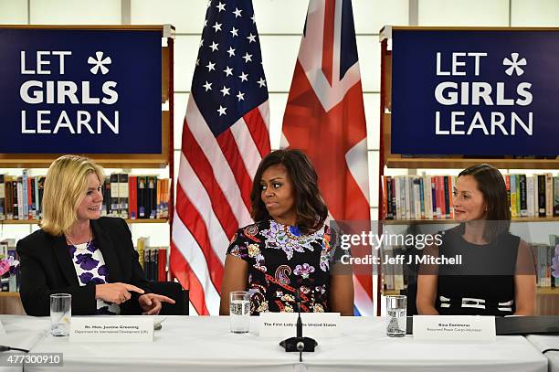 First Lady Michelle Obama sits between The UK Department of International Development's Justine Greening and returned Peace Corps Volunteer Bina...