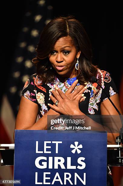First Lady Michelle Obama crosses her hands on her chest as she speaks to students as part of the 'Let Girls Learn Initiative' at the Mulberry School...