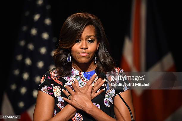 First Lady Michelle Obama crosses her hands on her chest as she speaks to students as part of the 'Let Girls Learn Initiative' at the Mulberry School...