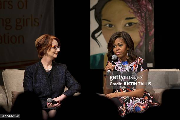 First Lady Michelle Obama and former Australian prime minister Julia Gillard take part in a discussion during a visit as part of the US government's...