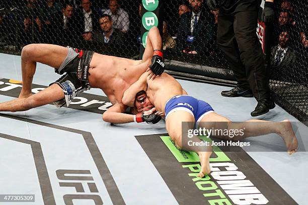 Ilir Latifi secures a choke submission against Cyrille Diabate in their light heavyweight fight during the UFC Fight Night London event at the O2...