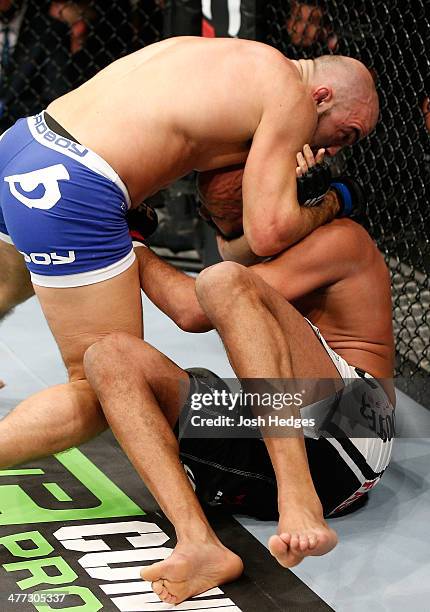 Ilir Latifi secures a choke submission against Cyrille Diabate in their light heavyweight fight during the UFC Fight Night London event at the O2...