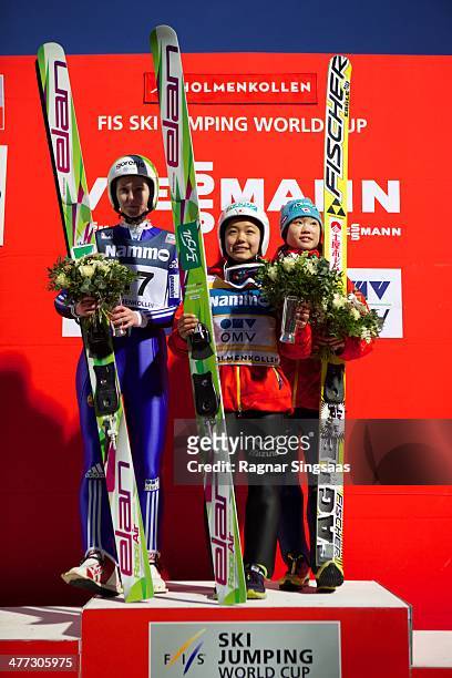 Katja Pozun of Slovenia takes second place, Sara Takanashi of Japan takes first place and Yuki Ito of Japan takes third place during the FIS Ski...