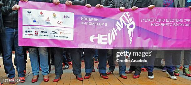 Bulgarian men wear high heels during the celebration of International Womens Day in the capital Sofia, Bulgaria on March 8, 2014. Bulgarians mark out...