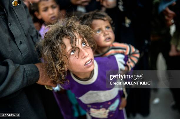 Syrians children arrive at the Akcakale crossing gate between Turkey and Syria at Akcakale in Sanliurfa province on June 16, 2015. Turkey said it was...