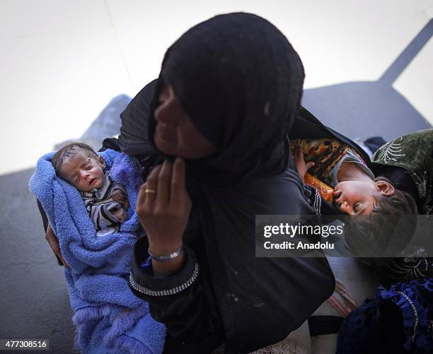 One month old Syrian baby sleeps in his mother's arms after crossing into Turkey from Akcakale Border Gate in Sanliurfa, Turkey on June 16, 2015....