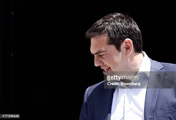 Alexis Tsipras, Greece's prime minister, reacts as he leaves Maximos Mansion to attend a meeting of the Syriza party secretariat in Athens, Greece,...