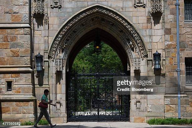 Pedestrian walks past Harkness Gate on the Yale University campus in New Haven, Connecticut, U.S., on Friday, June 12, 2015. Yale University is an...