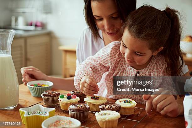 mother and daughter baking - pasteles de hada fotografías e imágenes de stock